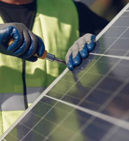 man-with-white-helmet-near-solar-panel